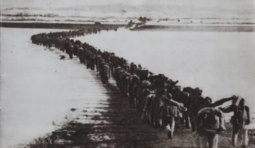 Chinese troops cross the Yalu River, 1950, to fight in the Korean War.